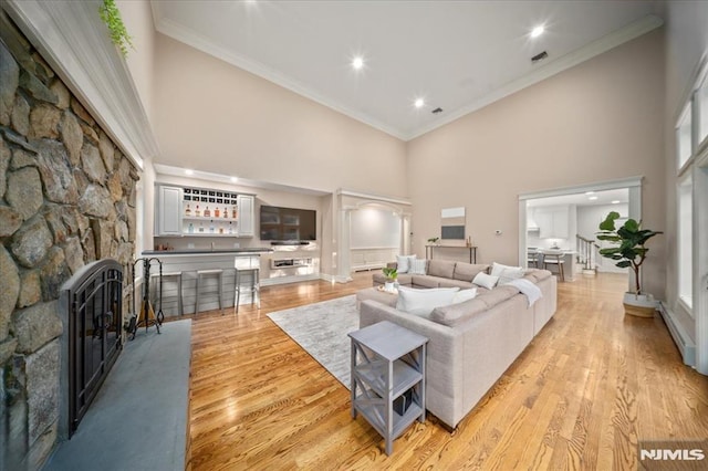 17 Sunset Ln, Upper Saddle River, NJ 07458 - living area with a high ceiling, ornamental molding, light wood finished floors, and a fireplace