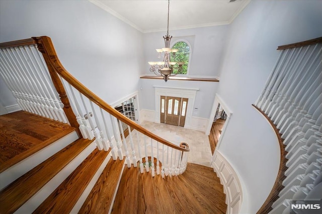17 Sunset Ln, Upper Saddle River, NJ 07458 - stairs with a chandelier, a high ceiling, wood finished floors, and crown molding