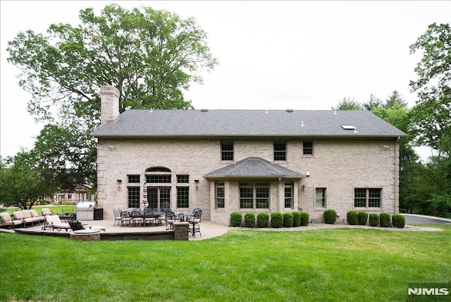 17 Sunset Ln, Upper Saddle River, NJ 07458 - back of house featuring a chimney, a patio area, and a lawn