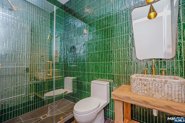 full bath featuring toilet, a stall shower, and tile walls