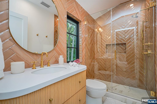 full bath featuring toilet, vanity, and a stall shower