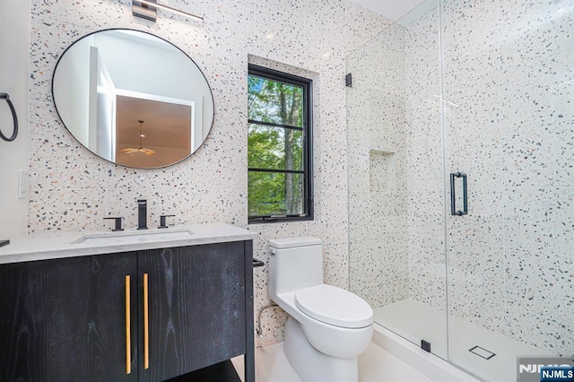 bathroom featuring a stall shower, vanity, toilet, and backsplash