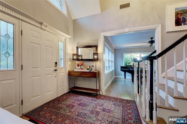155 W Clinton Ave, Tenafly, NJ 07670 - entryway with stairway, ceiling fan, wood finished floors, baseboards, and crown molding