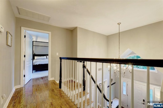 155 W Clinton Ave, Tenafly, NJ 07670 - hallway featuring a chandelier, an upstairs landing, wood finished floors, and baseboards
