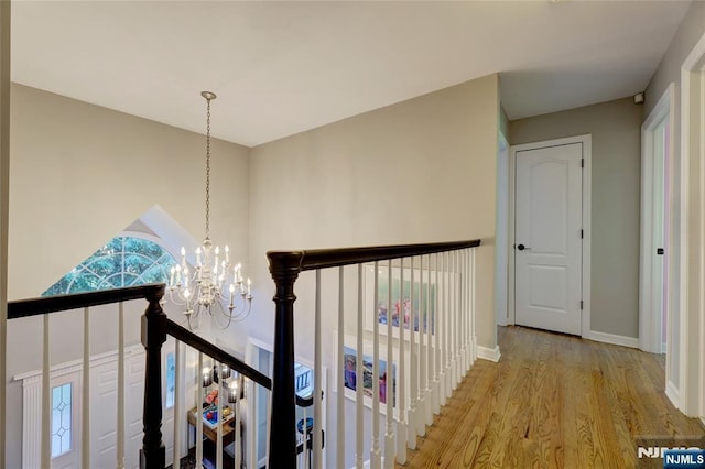 155 W Clinton Ave, Tenafly, NJ 07670 - hall featuring light wood finished floors, a chandelier, an upstairs landing, and baseboards