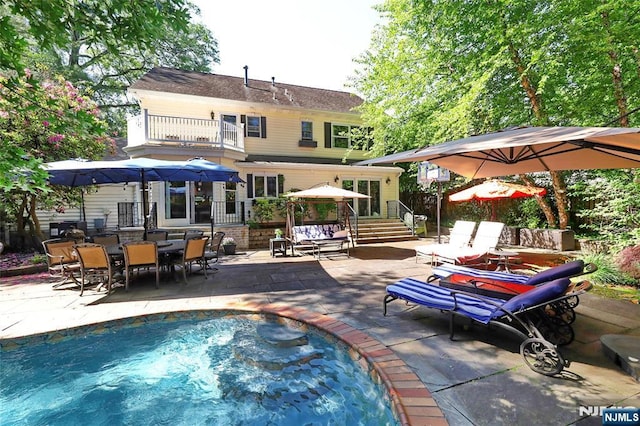 155 W Clinton Ave, Tenafly, NJ 07670 - rear view of property with a balcony, a patio, an outdoor pool, and outdoor dining area