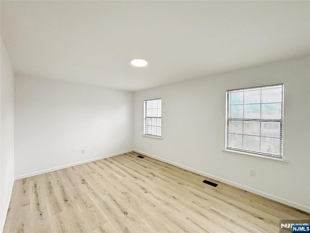 unfurnished room featuring wood finished floors and baseboards