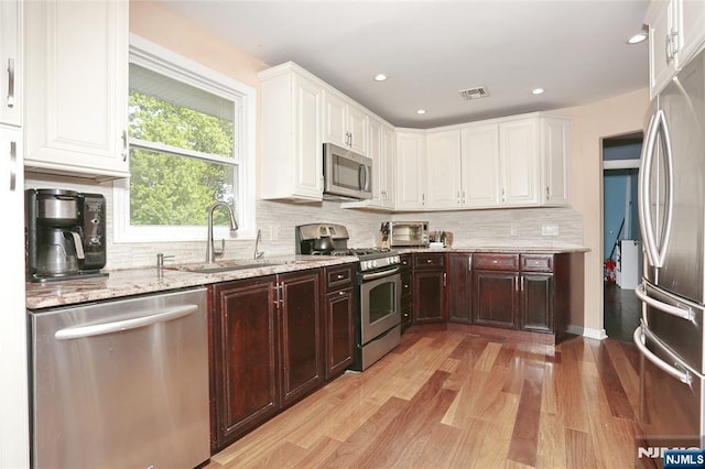 3-29 17th St, Fair Lawn, NJ 07410 - kitchen with appliances with stainless steel finishes, light wood-style flooring, white cabinets, and recessed lighting