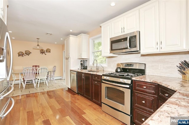 3-29 17th St, Fair Lawn, NJ 07410 - kitchen with stainless steel appliances, dark brown cabinets, a sink, white cabinetry, and recessed lighting