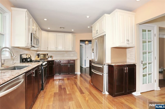 3-29 17th St, Fair Lawn, NJ 07410 - kitchen with stainless steel appliances, a sink, white cabinets, and recessed lighting