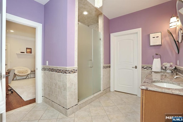 7 Newton Pl, Allendale, NJ 07401 - full bathroom featuring tile walls, tile patterned floors, a stall shower, double vanity, and a wainscoted wall