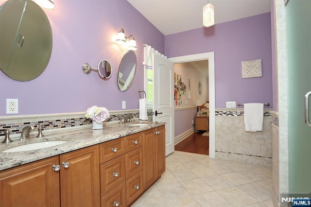 7 Newton Pl, Allendale, NJ 07401 - bathroom featuring tile patterned floors, tile walls, double vanity, and wainscoting