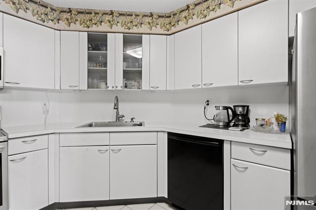 708 Harmon Cv, Secaucus, NJ 07094 - kitchen with black dishwasher, a sink, light countertops, and white cabinets