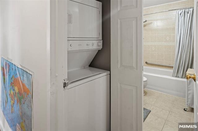 708 Harmon Cv, Secaucus, NJ 07094 - washroom with stacked washer / dryer and light tile patterned floors