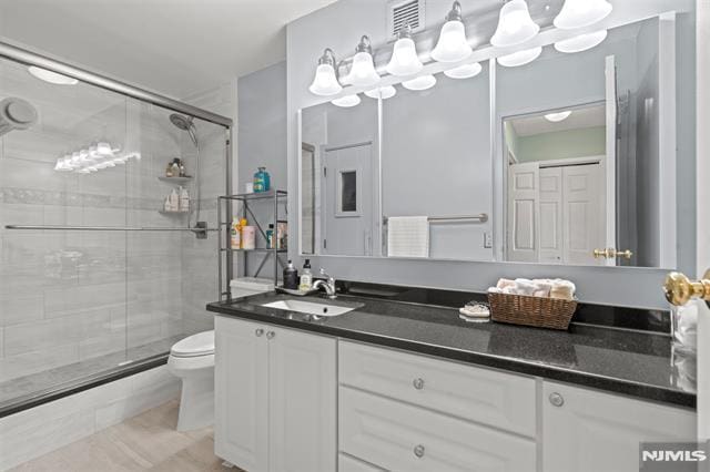 708 Harmon Cv, Secaucus, NJ 07094 - full bath featuring toilet, vanity, and a stall shower