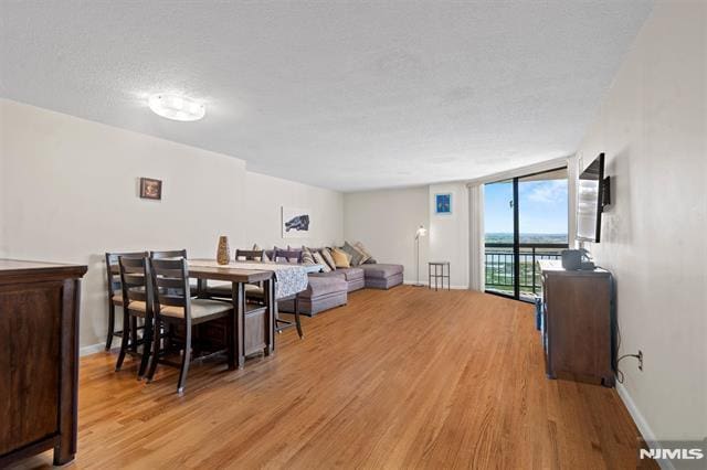 708 Harmon Cv, Secaucus, NJ 07094 - dining room with wood finished floors, floor to ceiling windows, and baseboards
