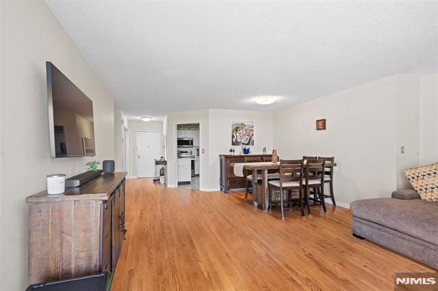 708 Harmon Cv, Secaucus, NJ 07094 - dining area with light wood finished floors and baseboards