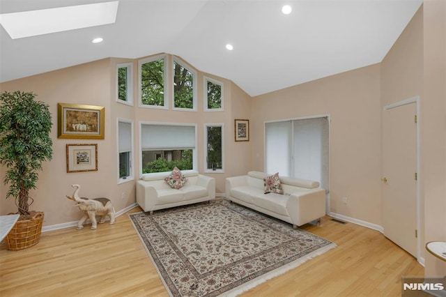 526 Rutland Ave, Teaneck, NJ 07666 - living area featuring a skylight, light wood finished floors, high vaulted ceiling, baseboards, and recessed lighting
