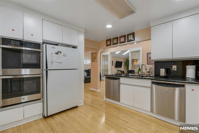 526 Rutland Ave, Teaneck, NJ 07666 - kitchen with appliances with stainless steel finishes, a sink, white cabinets, and recessed lighting