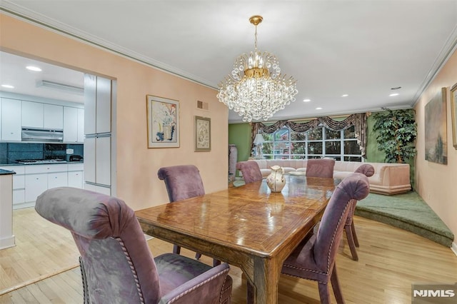 526 Rutland Ave, Teaneck, NJ 07666 - dining space featuring light wood-type flooring, a chandelier, crown molding, and recessed lighting