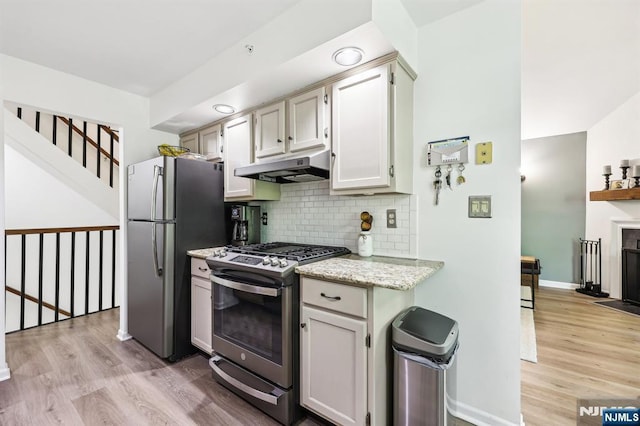 510 Mark Twain Way, Mahwah, NJ 07430 - kitchen with appliances with stainless steel finishes, under cabinet range hood, light wood-type flooring, decorative backsplash, and baseboards