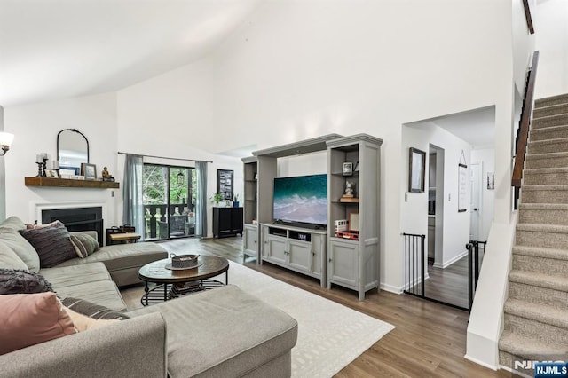 510 Mark Twain Way, Mahwah, NJ 07430 - living room with high vaulted ceiling, stairway, dark wood finished floors, a fireplace, and baseboards