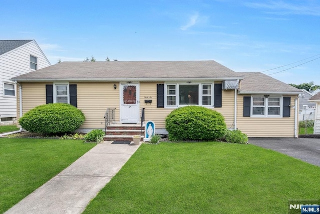 36 Bogert St, Totowa, NJ 07512 - view of front facade with a front yard and roof with shingles