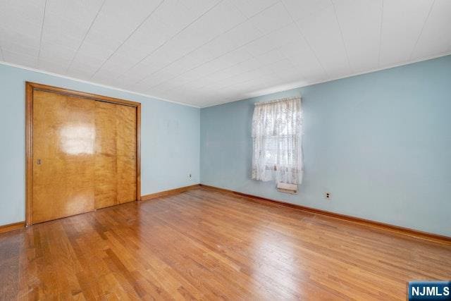 36 Bogert St, Totowa, NJ 07512 - unfurnished bedroom featuring wood finished floors and baseboards