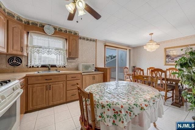 36 Bogert St, Totowa, NJ 07512 - kitchen featuring white appliances, light tile patterned floors, light countertops, wallpapered walls, and a sink