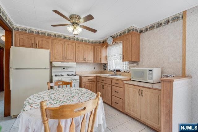 36 Bogert St, Totowa, NJ 07512 - kitchen with white appliances, under cabinet range hood, light tile patterned floors, and ceiling fan