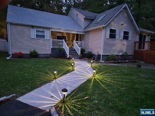 22 Elizabeth Rd, West Milford, NJ 07421 - view of front of property featuring a front lawn, a porch, and roof with shingles