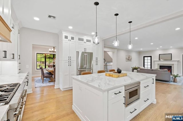 20 Aronow Pl, Mahwah, NJ 07430 - kitchen featuring high end refrigerator, light wood-style floors, glass insert cabinets, white cabinetry, and recessed lighting