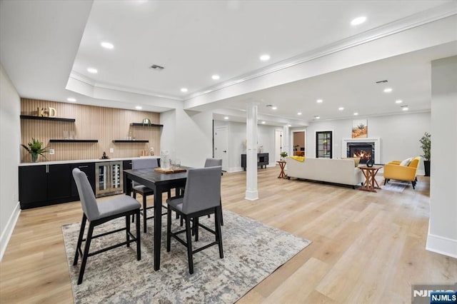 20 Aronow Pl, Mahwah, NJ 07430 - dining area with bar with sink, a warm lit fireplace, baseboards, light wood finished floors, and recessed lighting