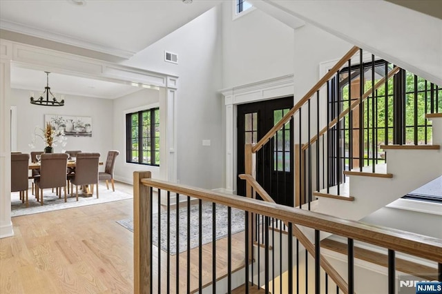 20 Aronow Pl, Mahwah, NJ 07430 - staircase with wood finished floors, a chandelier, baseboards, and vaulted ceiling