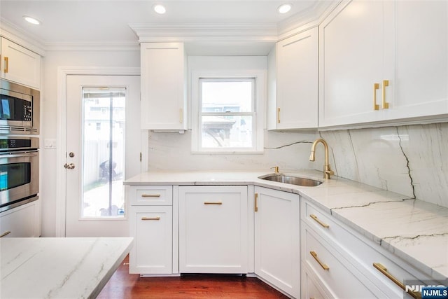 79 Palsa Ave, Elmwood Park, NJ 07407 - kitchen with stainless steel appliances, a sink, plenty of natural light, white cabinets, and crown molding