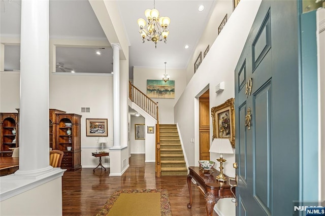 49 Quarry Dr, Woodland Park, NJ 07424 - foyer entrance featuring decorative columns, a high ceiling, a chandelier, dark wood-style floors, and crown molding