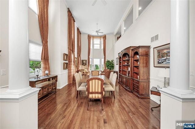 49 Quarry Dr, Woodland Park, NJ 07424 - dining area featuring ornate columns, a high ceiling, a ceiling fan, wood finished floors, and baseboards
