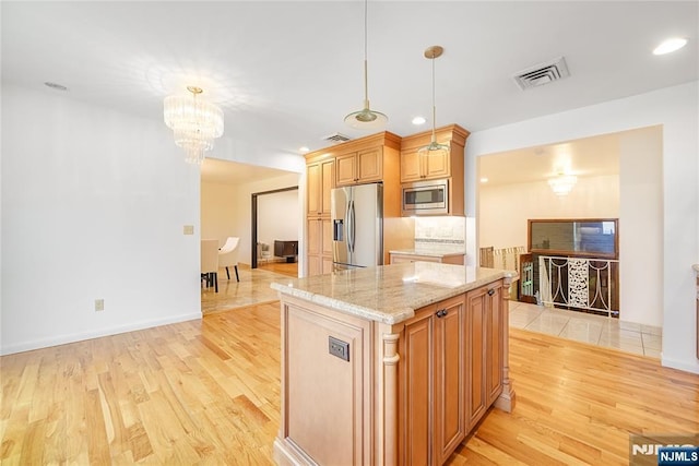 47 Venna Ave, North Haledon, NJ 07508 - kitchen with stainless steel appliances, light wood finished floors, a chandelier, light stone countertops, and recessed lighting