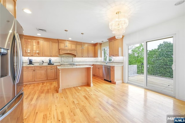 47 Venna Ave, North Haledon, NJ 07508 - kitchen with stainless steel appliances, light countertops, a chandelier, a center island, and backsplash