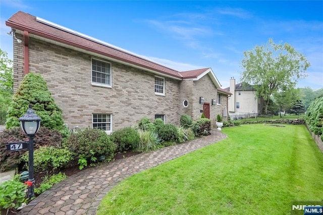 47 Venna Ave, North Haledon, NJ 07508 - back of house featuring a lawn and brick siding