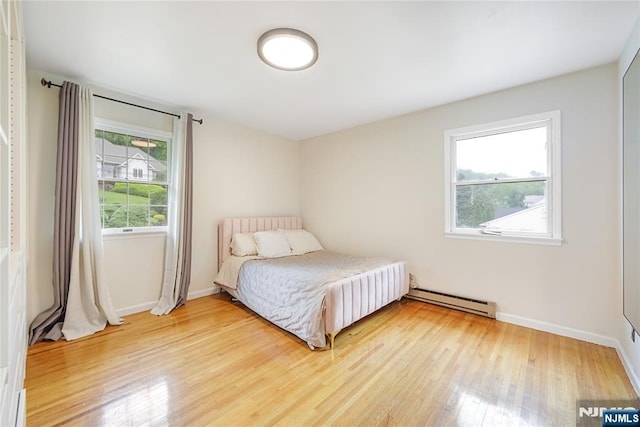 47 Venna Ave, North Haledon, NJ 07508 - bedroom with a baseboard radiator, light wood-type flooring, and baseboards