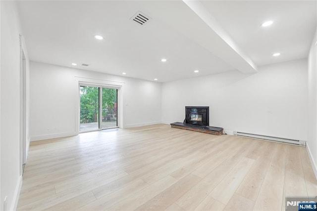 47 Venna Ave, North Haledon, NJ 07508 - unfurnished living room featuring a baseboard heating unit, light wood-style flooring, baseboards, and recessed lighting