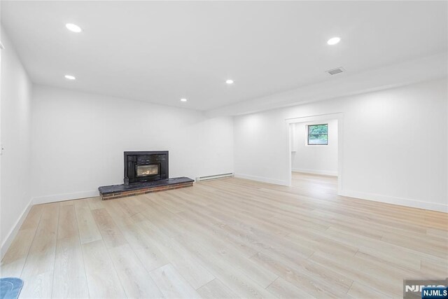 47 Venna Ave, North Haledon, NJ 07508 - unfurnished living room with a baseboard heating unit, light wood-type flooring, baseboards, and recessed lighting