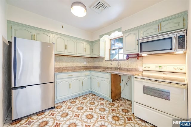 47 Venna Ave, North Haledon, NJ 07508 - kitchen featuring stainless steel appliances, a sink, tasteful backsplash, green cabinets, and light tile patterned floors