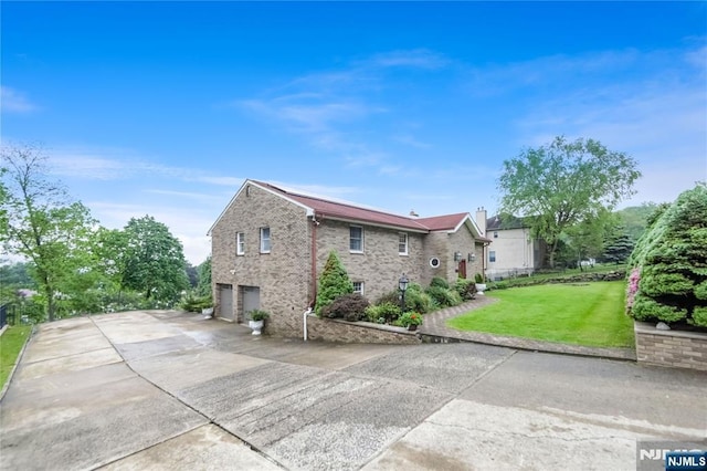 47 Venna Ave, North Haledon, NJ 07508 - view of side of property with an attached garage, brick siding, a lawn, and concrete driveway