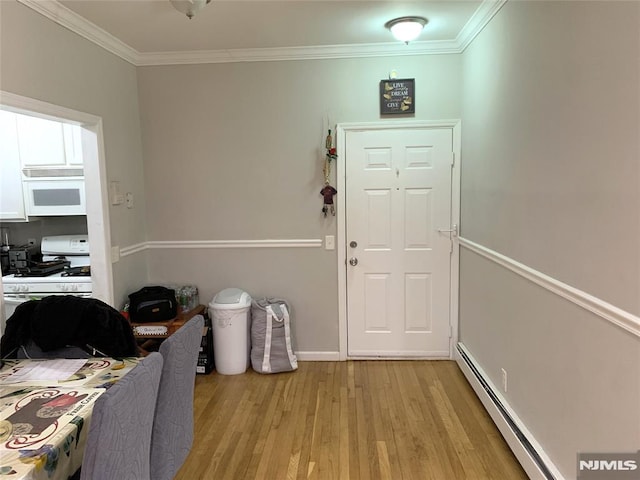 116 W 19th St Unit 1A, Bayonne, NJ 07002 - entryway with ornamental molding, a baseboard heating unit, light wood-type flooring, and baseboards