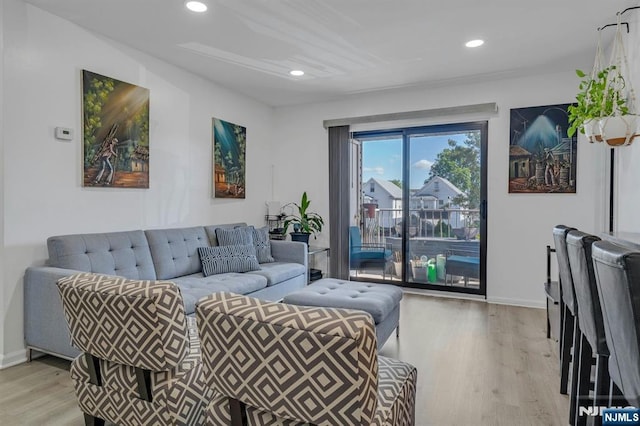 living area featuring wood finished floors, baseboards, and recessed lighting