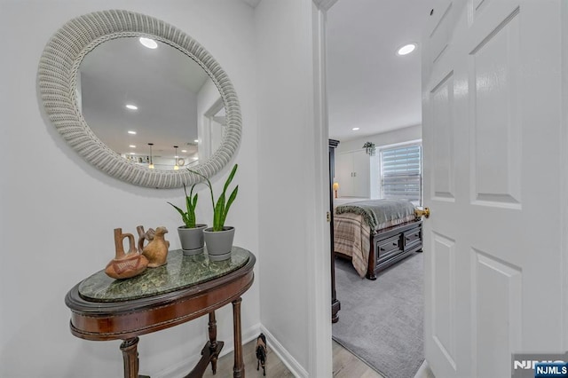 hall with baseboards, recessed lighting, and wood finished floors