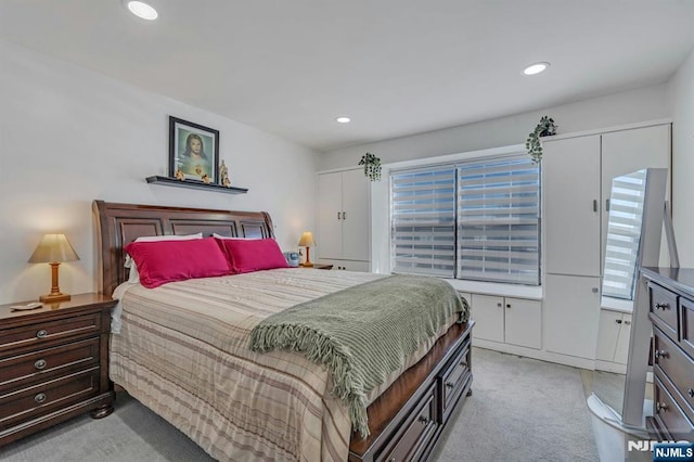 bedroom featuring light colored carpet and recessed lighting