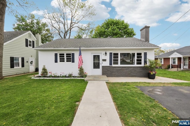 8 Oak St, Netcong Borough, NJ 07857 - view of front of house featuring a chimney, a front lawn, stone siding, and a shingled roof